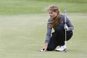 marking golf ball on putting green