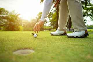 Golf ball on putting green