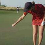 woman dropping golf ball
