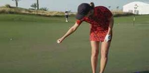 woman dropping golf ball
