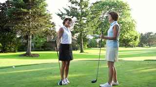women discussing golf